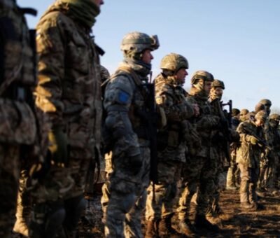Ukraine's Territorial Defence Force stand in line after a combat skills training session Amid heightened tension over Ukraine, French President Emmanuel Macron appears to have secured agreement for an 'in principle' summit between the US and Russian presidents